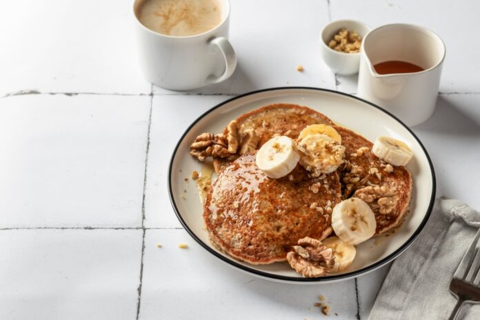 Healthy,Oatmeal,Pancakes,With,Banana,,Nuts,And,Honey,On,White
