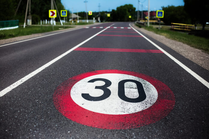 30km/h,Speed,Limit,Sign,Painted,On,Asphalting,Road.