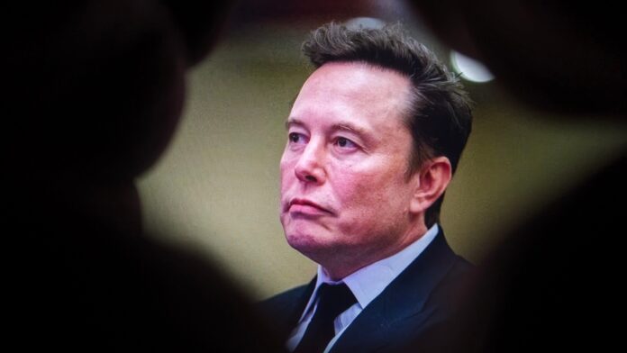 Elon,Musk,Is,Seen,Through,A,Hole,While,Testifying,Before